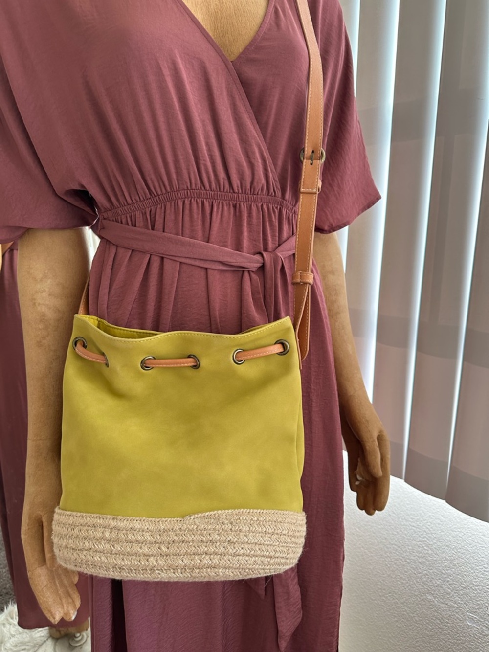 Gree. Drawstring Bucket Bag with Straw Trim 
Crossbody